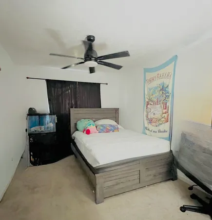 a bedroom with a bed and a tv on the dresser