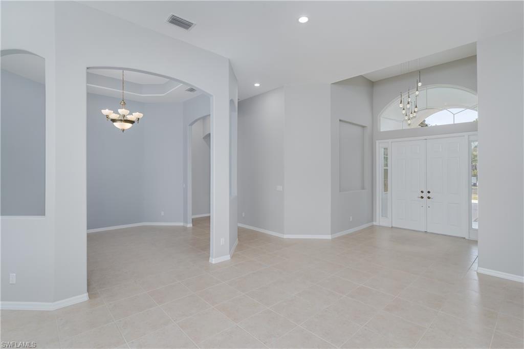 510 13th Street Northwest Naples, FL 34120 - Photo 17 of 50 an empty room with white walls and mirror
