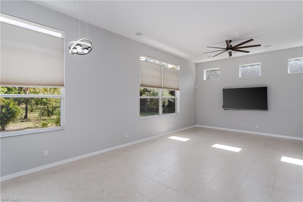 510 13th Street Northwest Naples, FL 34120 - Photo 18 of 50 en empty room with windows and ceiling fan