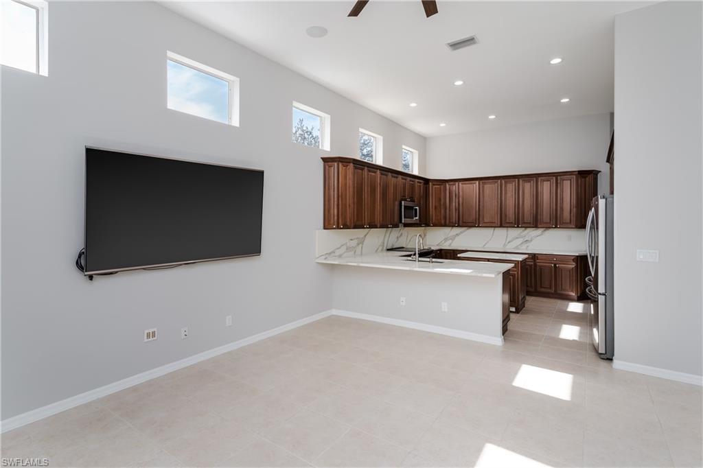 510 13th Street Northwest Naples, FL 34120 - Photo 21 of 50 a white kitchen with a sink and a large mirror
