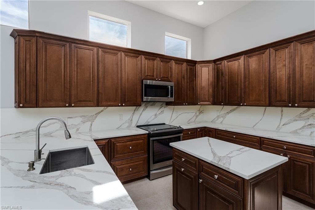 510 13th Street Northwest Naples, FL 34120 - Photo 25 of 50 a kitchen with a sink stove and microwave