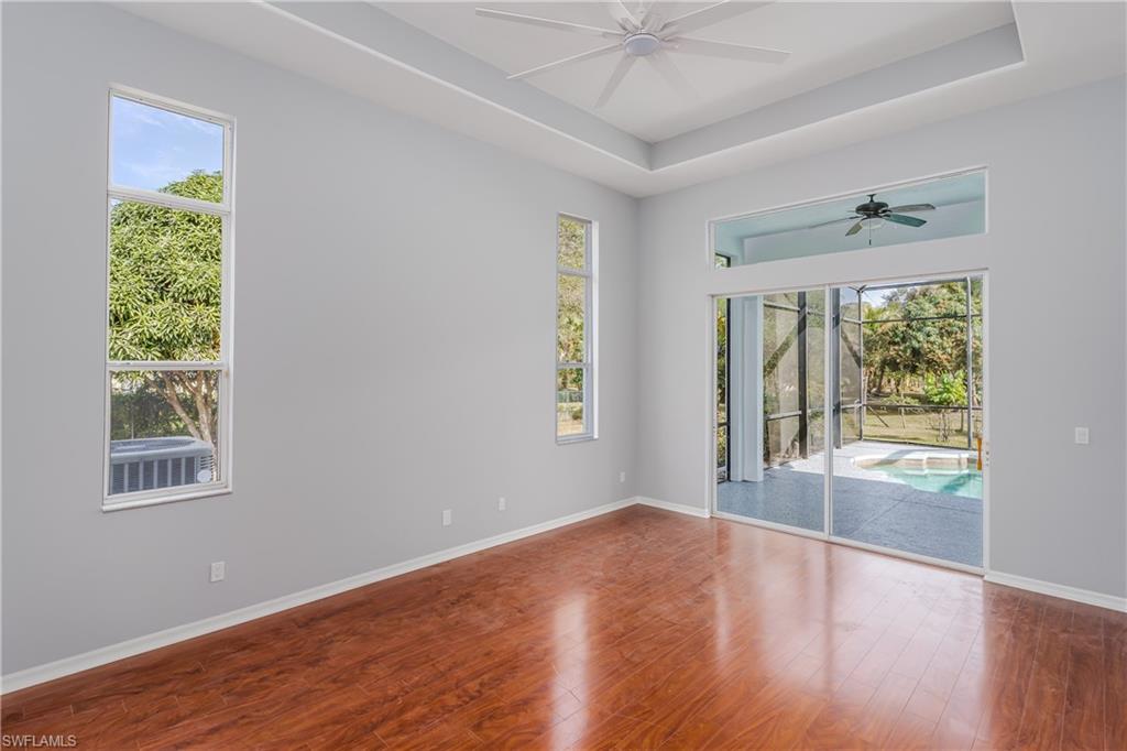 510 13th Street Northwest Naples, FL 34120 - Photo 29 of 50 a view of an empty room with wooden floor and a window