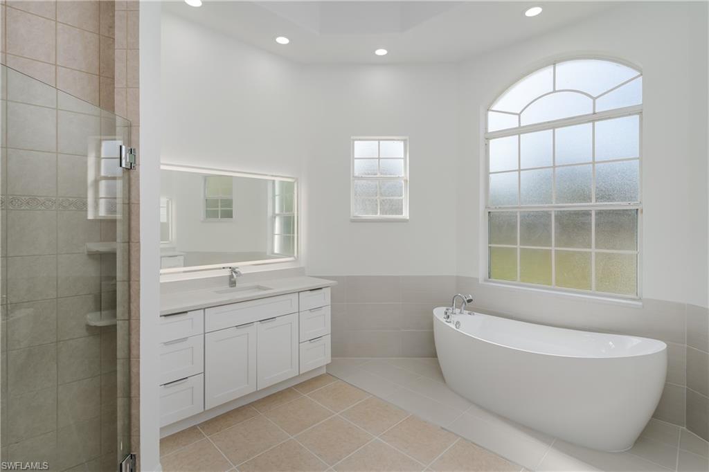 510 13th Street Northwest Naples, FL 34120 - Photo 31 of 50 a spacious bathroom with a bathtub and a shower