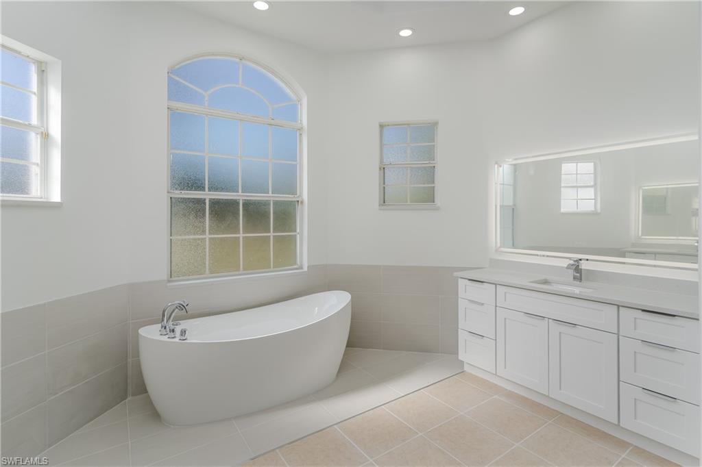 510 13th Street Northwest Naples, FL 34120 - Photo 32 of 50 a white bath tub sitting next to a window