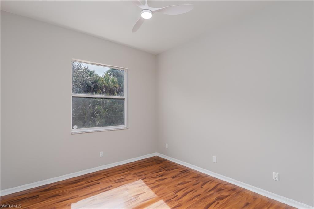 510 13th Street Northwest Naples, FL 34120 - Photo 37 of 50 an empty room with wooden floor and windows