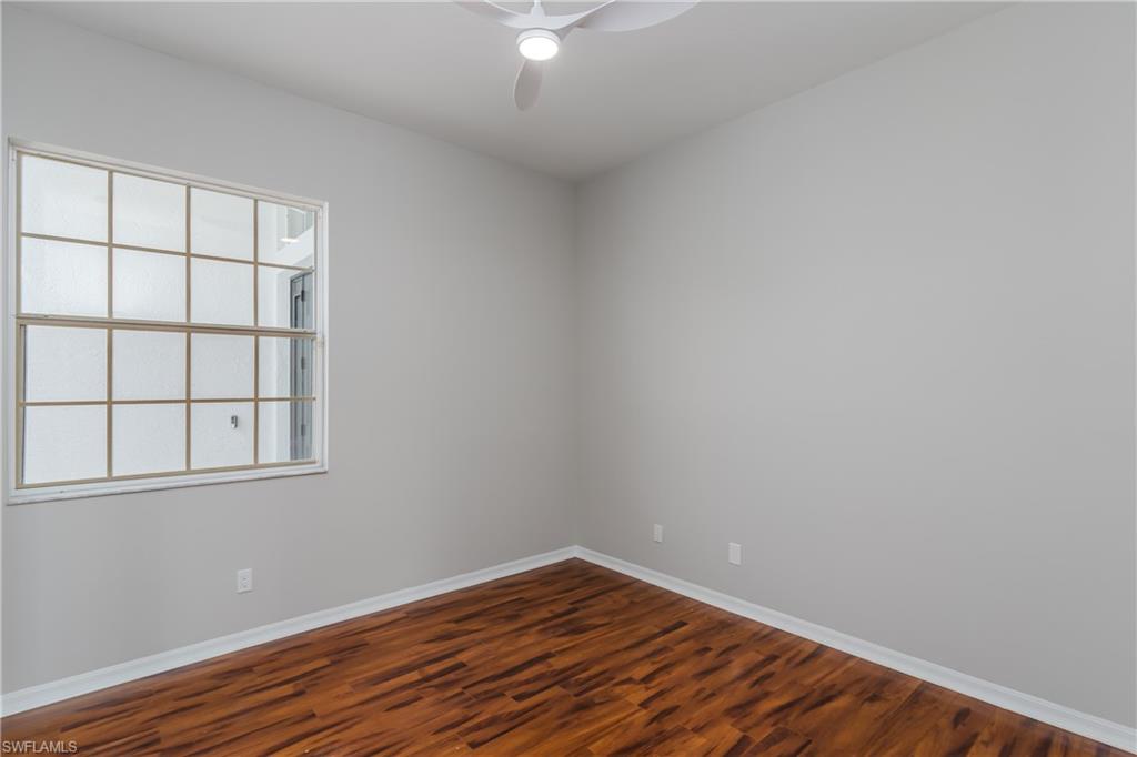510 13th Street Northwest Naples, FL 34120 - Photo 39 of 50 an empty room with wooden floor and windows