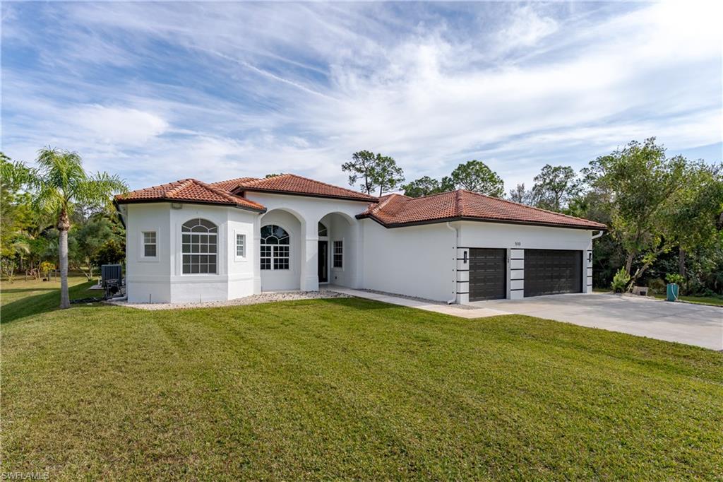 510 13th Street Northwest Naples, FL 34120 - Photo 4 of 50 a view of a house with a yard