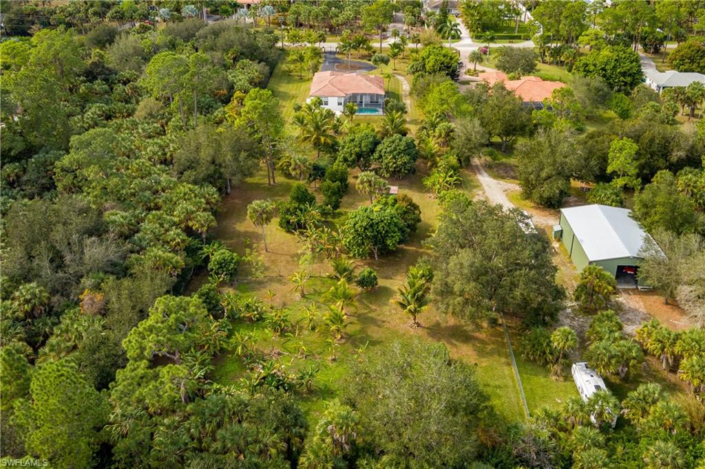 510 13th Street Northwest Naples, FL 34120 - Photo 47 of 50 an aerial view of residential house with swimming pool and green space