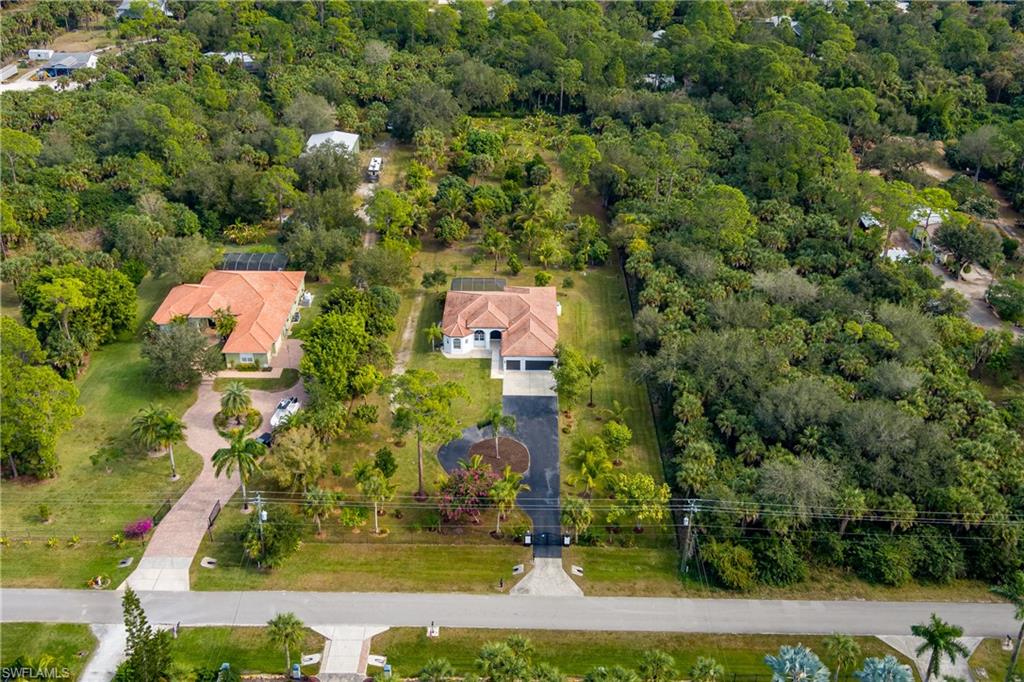 510 13th Street Northwest Naples, FL 34120 - Photo 48 of 50 an aerial view of residential houses with outdoor space and trees