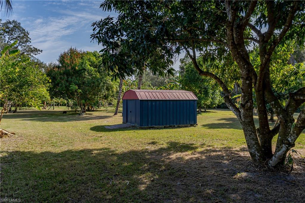 510 13th Street Northwest Naples, FL 34120 - Photo 10 of 50 a backyard of a house with lots of green space