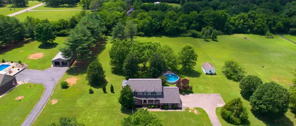an aerial view of a house with yard swimming pool and outdoor seating