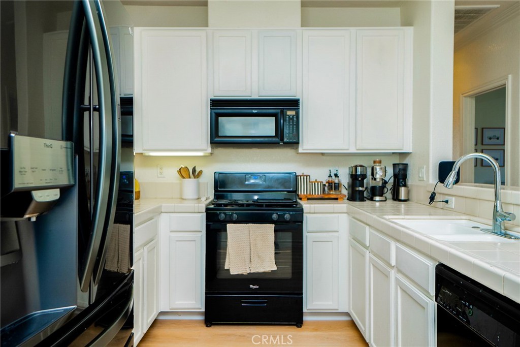 7331 Shelby Place, Unit 91 Rancho Cucamonga, CA 91739 - Photo 12 of 34 a kitchen with a refrigerator stove and sink
