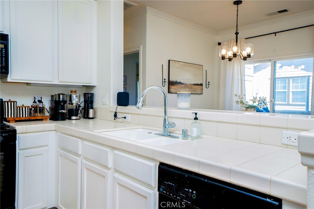 7331 Shelby Place, Unit 91 Rancho Cucamonga, CA 91739 - Photo 13 of 34 a kitchen with a sink and a refrigerator