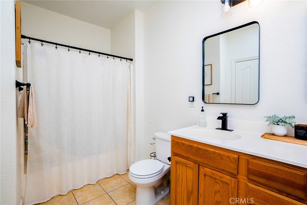 7331 Shelby Place, Unit 91 Rancho Cucamonga, CA 91739 - Photo 20 of 34 a bathroom with a granite countertop sink toilet and shower