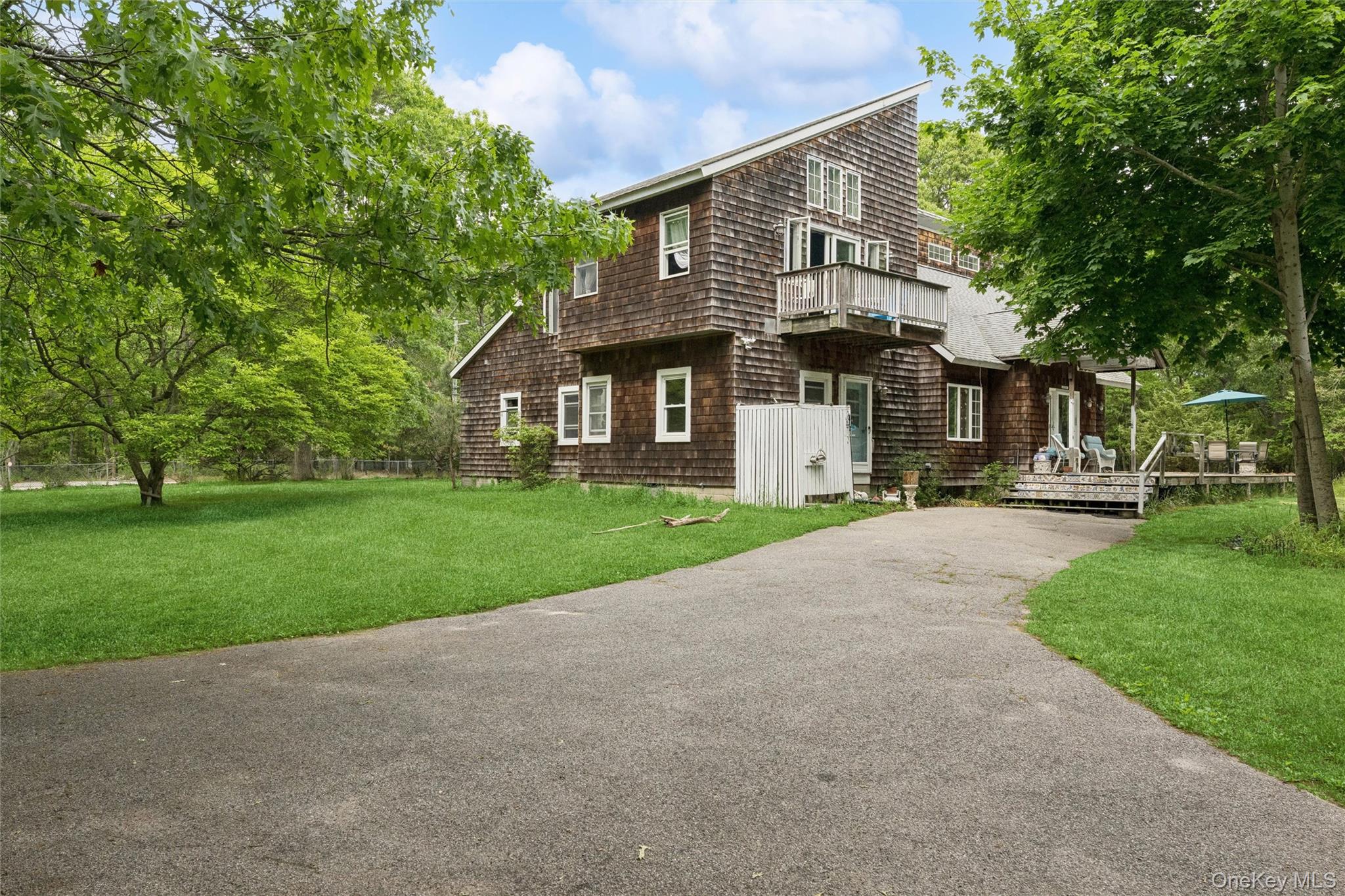 131 Red Creek Road Hampton Bays, NY 11946 - Photo 2 of 35 a front view of house with yard and green space