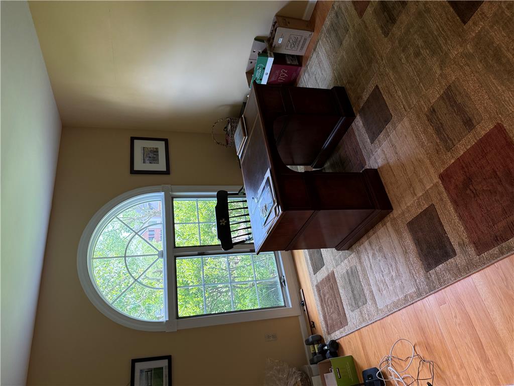 4114 Rochelle Drive Allentown, PA 18104 - Photo 20 of 35 Natural light pours through a large arched window, illuminating the warm hardwood flooring and inviting home office.