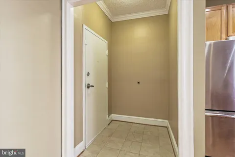 a view of a hallway with a refrigerator