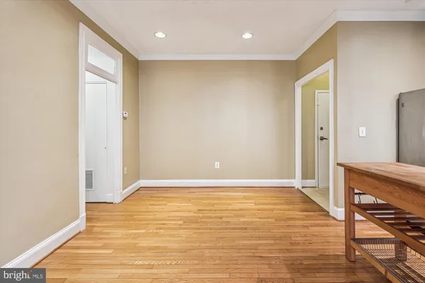a view of an empty room with wooden floor