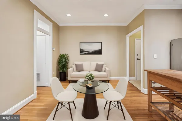 a view of a dining room with furniture and wooden floor