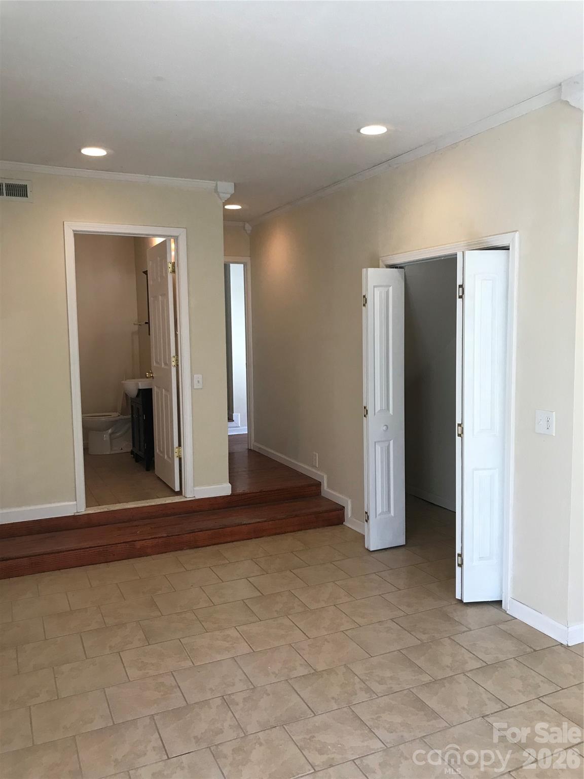 545 Avery Creek Road Arden, NC 28704 - Photo 20 of 35 a view of a hallway with wooden shelves