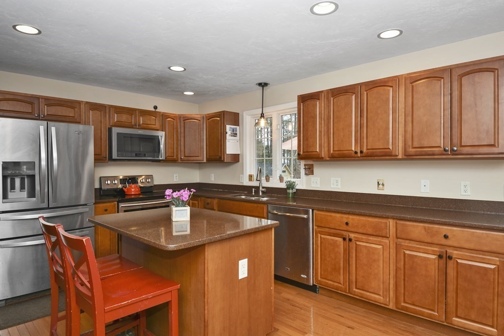 26 Tannery Road Sturbridge, MA 01518 - Photo 10 of 42 a kitchen with stainless steel appliances granite countertop a sink stove microwave and refrigerator