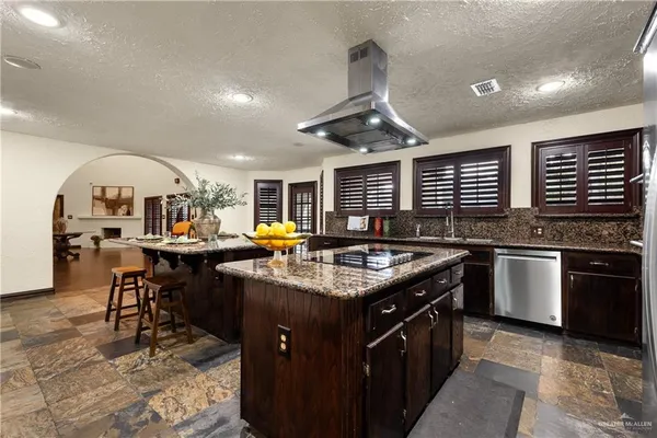 a kitchen with stainless steel appliances granite countertop a stove and a sink
