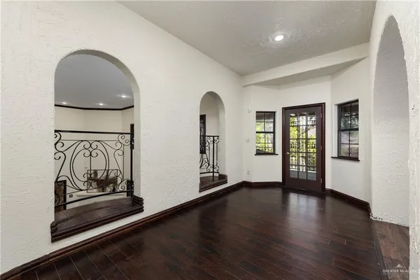 a view of a room with wooden floor and furniture