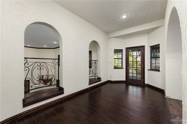a view of a room with wooden floor and furniture