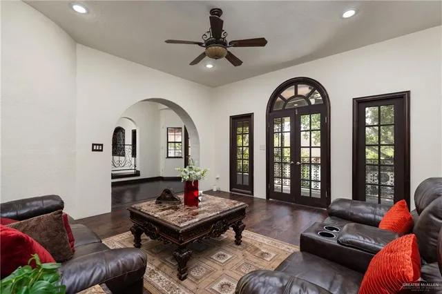 a living room with furniture a rug and a chandelier