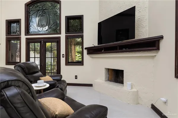 a living room with furniture a flat screen tv and a fireplace