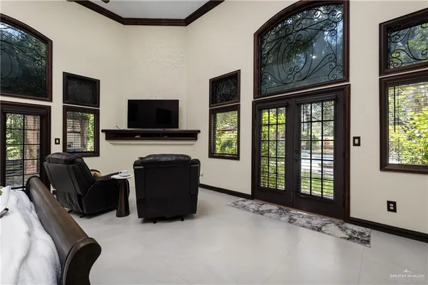 a living room with furniture a flat screen tv and a fireplace