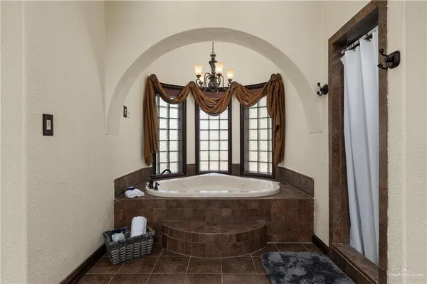 a bedroom with a bed and a ceiling fan