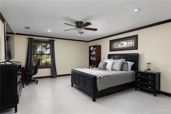 a bedroom with a bed and a chandelier