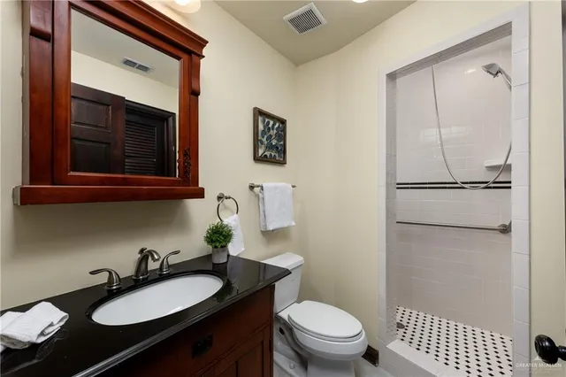 a bathroom with a sink a mirror and a toilet