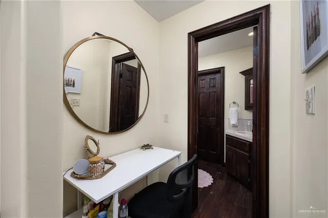 a bathroom with a granite countertop sink toilet and a mirror