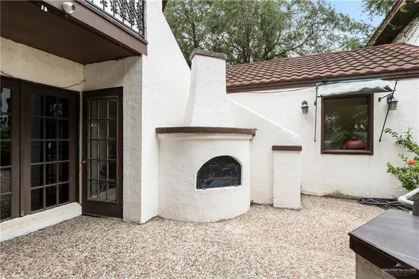 a view of a fire pit with large trees