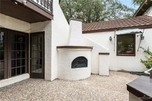 a view of a fire pit with large trees