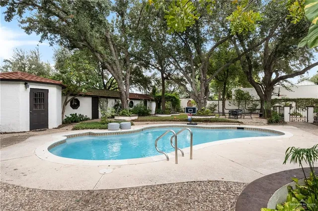 a view of a house with swimming pool and sitting area