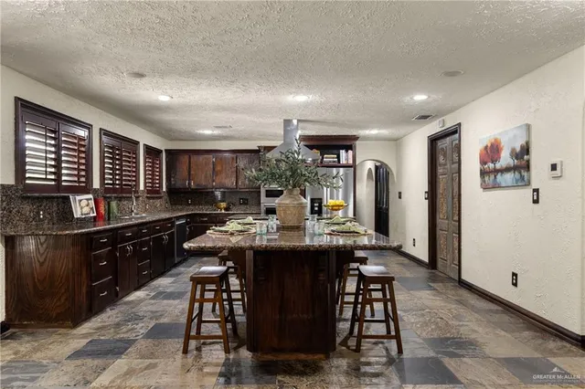 a kitchen with a table and chairs in it