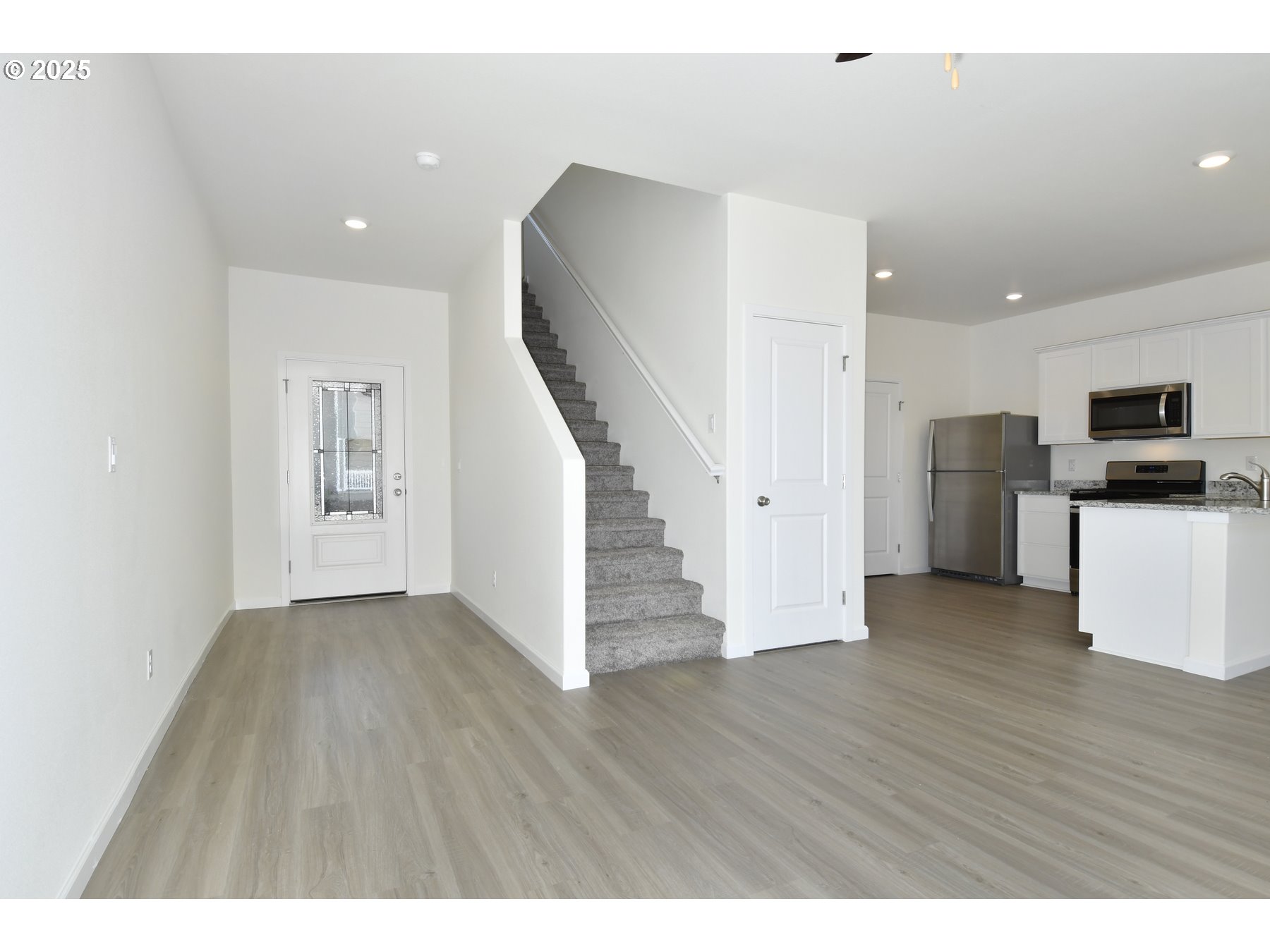 3907 Southwest Duniway Lane Gresham, OR 97080 - Photo 7 of 24 a view of empty room with wooden floor and electronic appliances