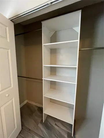 a bathroom with a toilet a sink a tub and mirror