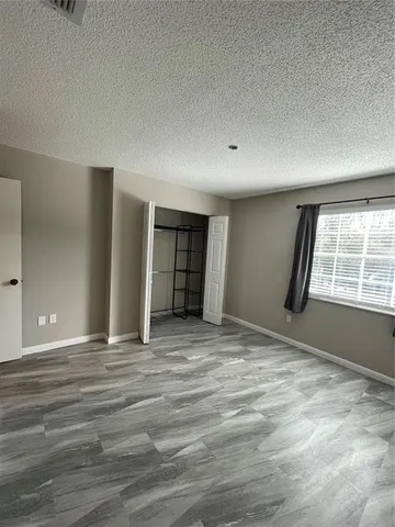 a bathroom with a granite countertop sink a toilet and a mirror