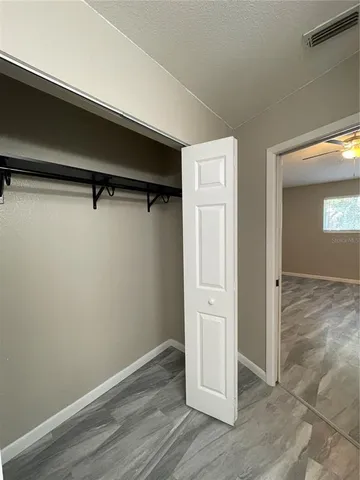 an empty room with large windows