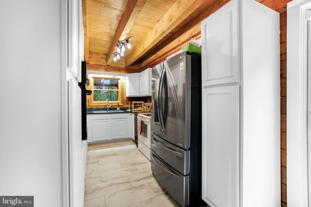 a kitchen with a refrigerator and a stove