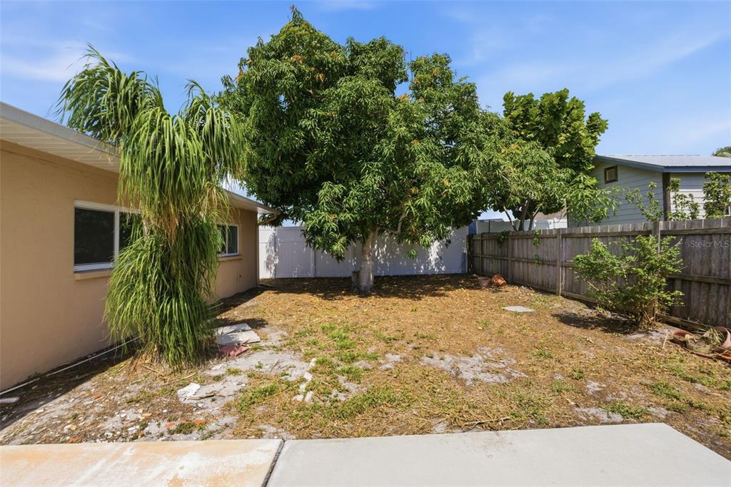 4536 Webber Street Sarasota, FL 34232 - Photo 28 of 45 a yellow house with tree in front of it