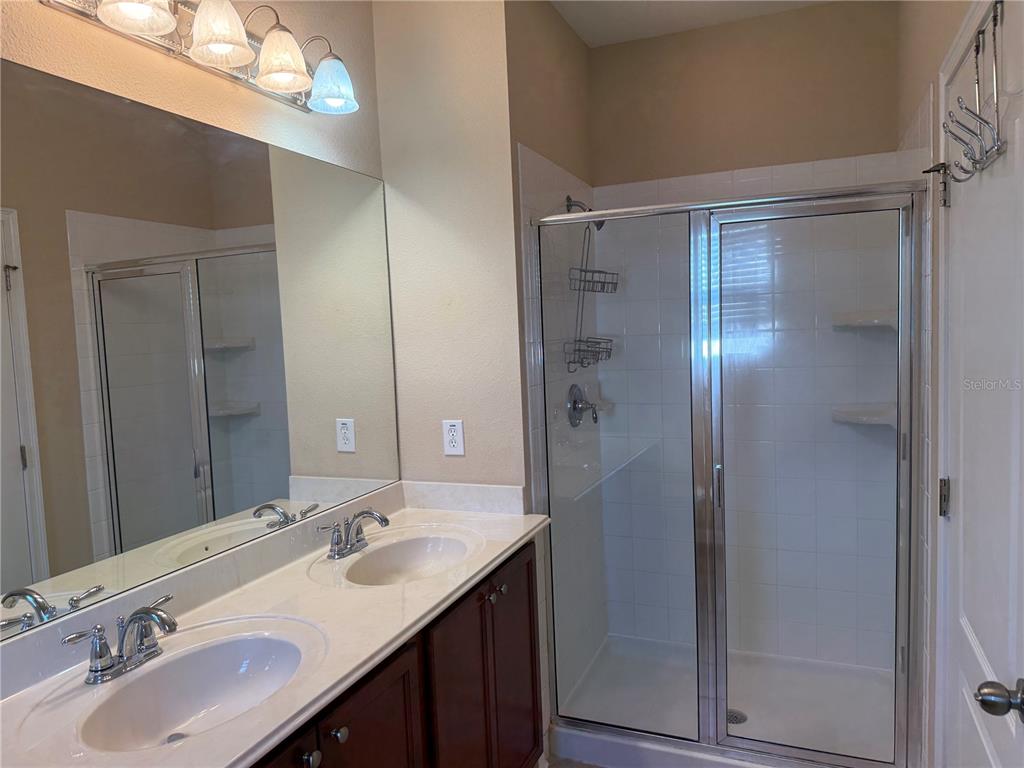 12910 Calderdale Avenue Windermere, FL 34786 - Photo 12 of 24 a bathroom with a double vanity sink mirror and shower