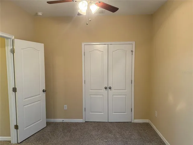 an empty room with closet area
