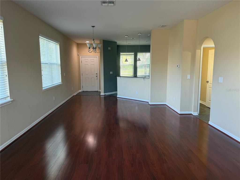 12910 Calderdale Avenue Windermere, FL 34786 - Photo 8 of 24 a view of an empty room with wooden floor and a window