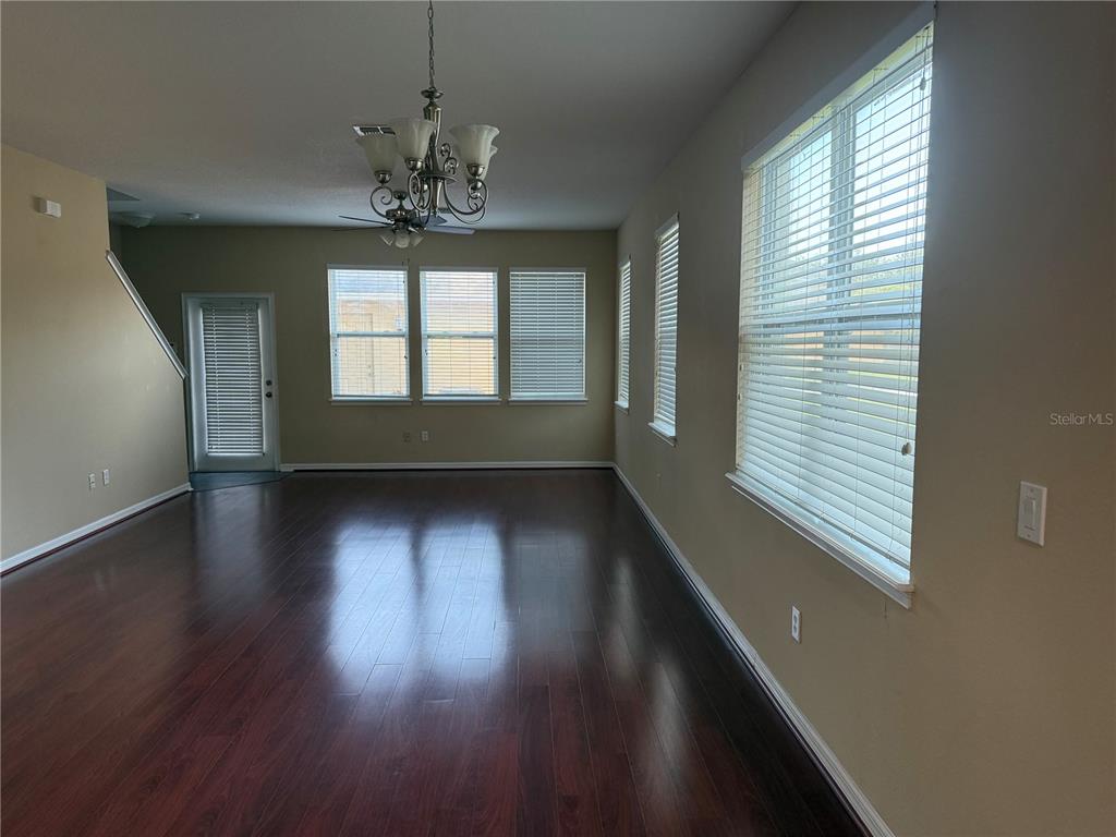12910 Calderdale Avenue Windermere, FL 34786 - Photo 9 of 24 an empty room with wooden floor and windows