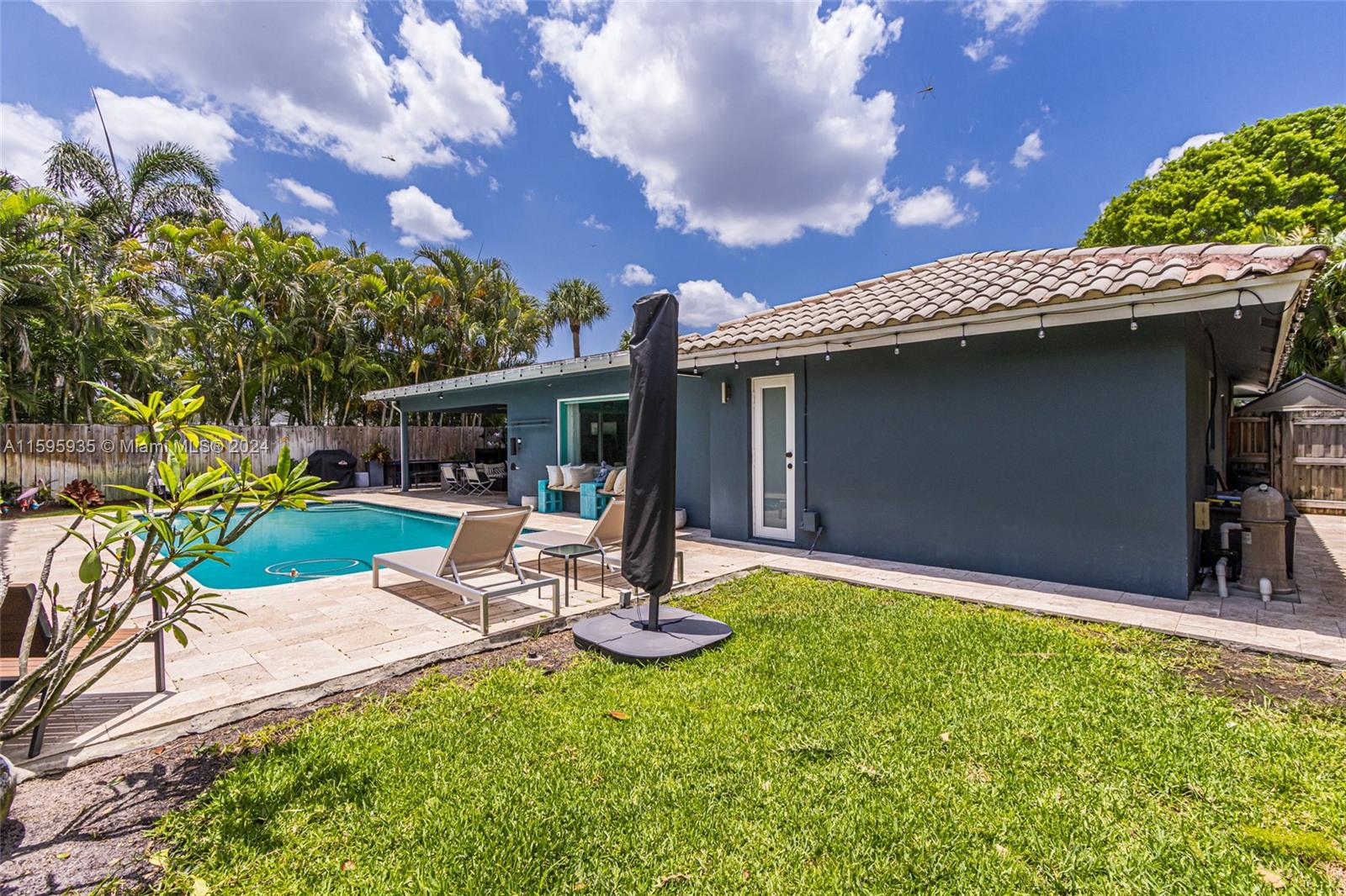 20 Burning Tree Lane Boca Raton, FL 33431 - Photo 12 of 64 a view of a patio with a table and chairs under an umbrella